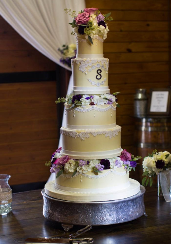 Yellow Wedding Cake with White Lace Details and Flowers