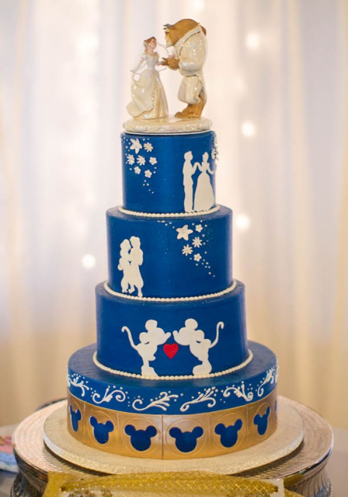 Blue and White Wedding Cake with Disney Silhouette Details and Beauty and the Beast Cake Topper